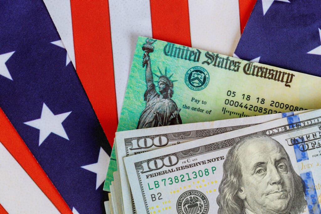 An American flag and money represent paying taxes. 