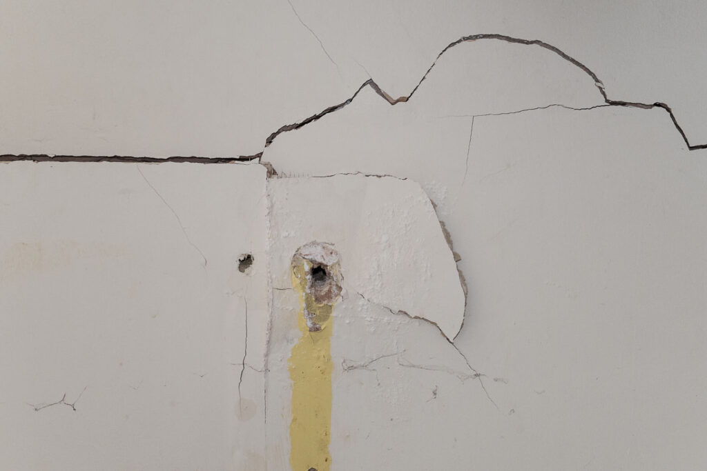 A cracked interior wall damaged by a bad tenant in Chandler, AZ